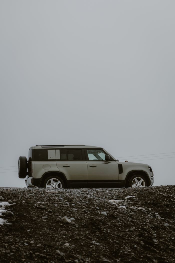 Explore rugged terrains with this SUV in a foggy setting. Perfect for adventure and travel enthusiasts.